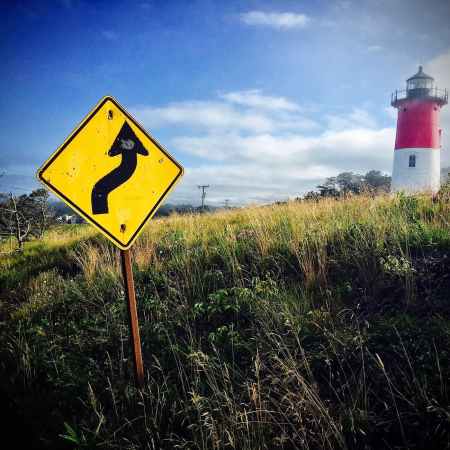 lighthouse with road sign